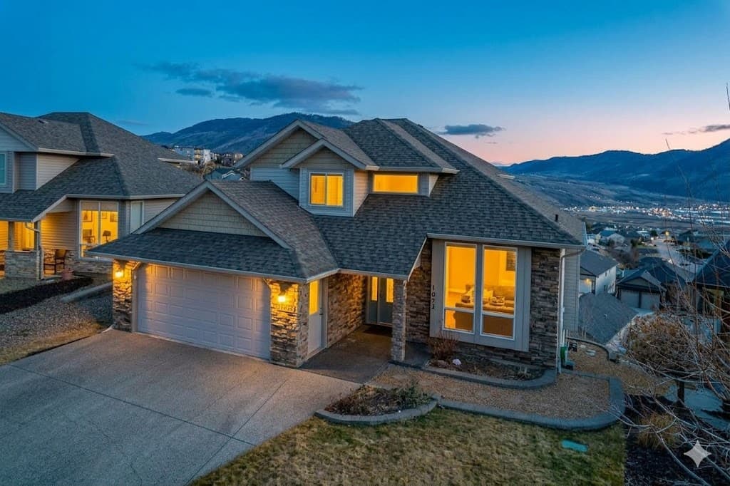 1872 Red Tail Crescent - Twilight exterior with stone facade and mountain views