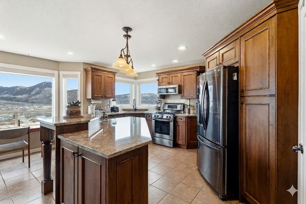 Kitchen detail with dark wood cabinets and granite island